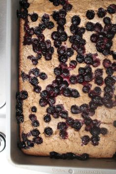 a pan filled with blueberries sitting on top of a stove