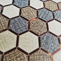 an array of hexagonal tiles are arranged in different colors and patterns on the floor