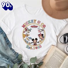 100 Years Disney Characters Retro Mickey And Friends T-Shirt   Your everyday style essential. Made with soft, breathable fabrics for comfort all day long. Choose from a variety of designs and colors to showcase your personal style. Perfect for casual outings or layering with other pieces. Versatile, timeless, and a must-have in any wardrobe.100 Years Disney Characters Retro Mickey And Friends T-Shirt – Our Custom T-shirts are what you are looking for. Made with highly breathable and so Friends T Shirt, Disney 100, Mickey Mouse Cartoon, Friends Tshirt, Mickey And Friends, Custom T Shirts, Disney Mickey Mouse, Fashion Essentials, Everyday Style