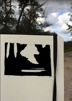 a white refrigerator freezer sitting on top of a dirt road