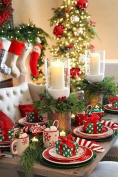 a table set for christmas with candles and decorations