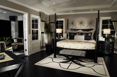 a bedroom with black and white decor in it