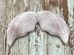 an image of a pair of wings on wood