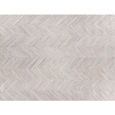 an area rug with white and beige chevrons