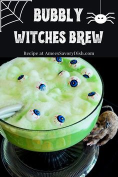 a green drink in a glass with blue eyes on it and the words bubbley witches brew