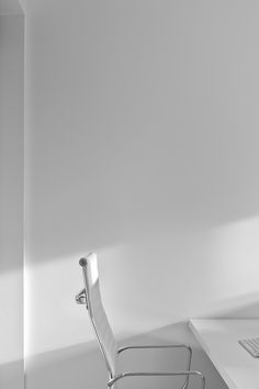 a white chair sitting in front of a computer desk