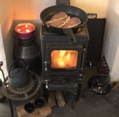 an old fashioned stove with some food cooking in it