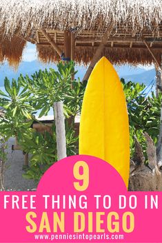 a yellow surfboard sitting under a thatched roof with the words free things to do in san diego