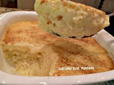 a close up of a piece of food in a white dish with a spoon sticking out of it