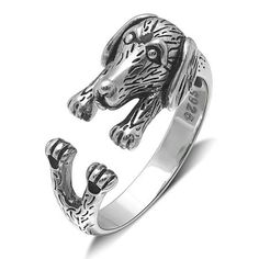 a silver ring with an animal head on it's face and two claws in the middle