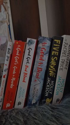 a row of books sitting on top of a bed