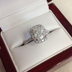 an oval shaped diamond ring in a wooden box