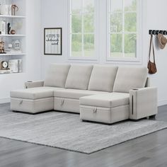 a living room with a sectional couch and bookshelves on the wall next to it