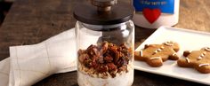 cookies and granola in a glass jar on a table next to baking utensils