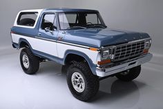 a blue and white pick up truck on a gray background