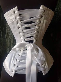 Quality construction and top end materials make my beautiful hand crafted corsets second to none. Designed to embrace your curves perfectly this heirloom corset will be the perfect romantic traditional piece for your wedding trousseau Please supply Full bust and cup size Waist at smallest Hip at widest Allow 4-6 weeks until shipping Wedding Overbust Corset With Boning, Formal Overbust Corset With Boning, Fitted Underbust Corset Belt For Wedding, Fitted Overbust Corset With Boning, Underbust Corset Dress With Boning For Wedding, Overbust Corset With Boning And Fitted Bodice, Wedding Underbust Corset With Lace Bodice, Strapless Corset Belt For Wedding, Elegant White Corset Dress With Boning