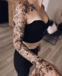 a woman with tattoos on her arm and arms