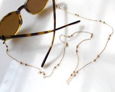 more sunglasses chain in DearDanielleJewelry: https://www.etsy.com/shop/DearDanielleJewelry?ref=seller-platform-mcnav&section_id=28433527 gold beads sunglasses chain, gold beads glasses chain necklace. **framed gems, and charms in the jewelry is plated. *All the jewelry in my shop will be sent in cotton pouch. If you want gift box wrapping, please let us know we will send your jewelry in gift box. Beads Sunglasses, Beads Glasses, Beaded Sunglasses, Chain Mask, Tortoise Glasses, Glasses Chains, Sunglasses Chain, Gold Glasses, Mask Chain