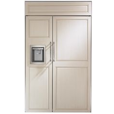 a white refrigerator freezer sitting inside of a wooden cabinet next to a metal door