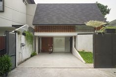 a house with a bike parked in front of it and an open door on the other side