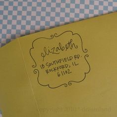 a yellow folder with the words elizabeth written on it and a checkered tablecloth