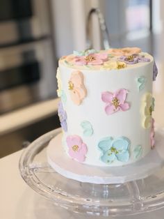 there is a white cake with flowers on it