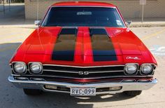 a red and black car parked in a parking lot