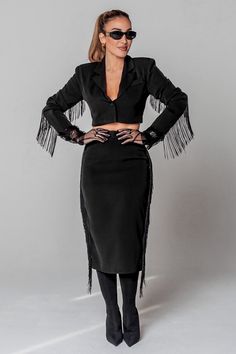 VIVIANNA Blazer Style: Bold and Sophisticated with a Dramatic Flair Color: Deep Black Material: Luxurious Fabric Blend; Lined Collar: Notched Lapels for Timeless Elegance Sleeves: Full Length with Fringe Detailing for a Fashion-Forward Look Features: Cropped Cut with a Single Button Closure Fit: True to Size. Size up for Longer Length Fabric: 98% Polyester, 2% Spandex Versatility: From Office Chic to Evening Glamour Care: Dry Clean Recommended Model Measurements: Model 1: Height: 5'6" | Bust: 34 Side Fringe, Office Chic, Blazer Style, Power Suit, Jumpsuit Jacket, Luxurious Fabric, Skirt Style, Leather Shops, Denim Leggings