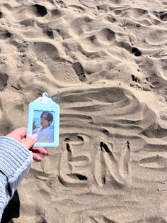 a person holding an ornament in the sand