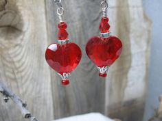 This is a fun pair of earrings which can be worn out to a special event, to a wedding, to dress up a casual outfit or semi formal outfits.  The elegant earrings feature a 20mm red cut glass crystal, two small red beads, a red bicone crystal, a rhinestone spacer and silver tone findings.  These earrings measure approximately 2 1/4" from the top of the lever back ear wire to the bottom.  The earrings in the photo are the exact pair you will receive and are ready to ship.  Designed and handcrafted by me for you in my smoke free studio. No returns accepted but please contact me should there be a problem with your order. Carefully packaged and shipped in a white box enclosed in a bubble lined envelope.  Free shipping is USPS Ground Advantage with tracking.  Estimated delivery is 2-6 days. Nickel Free Red Crystal Earrings For Parties, Elegant Party Earrings With Heart Beads, Elegant Heart-shaped Beaded Earrings For Gift, Elegant Beaded Earrings For Valentine's Day Party, Red Heart Beads Earrings For Party, Elegant Red Heart Beads Earrings, Elegant Beaded Earrings With Heart Beads For Parties, Elegant Heart Beaded Dangle Earrings, Elegant Heart Beads Earrings For Valentine's Day