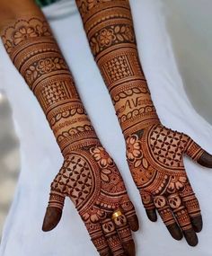 two hands with henna designs on them