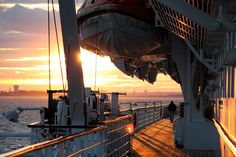 the deck of a cruise ship at sunset