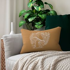 a white couch sitting next to a green plant