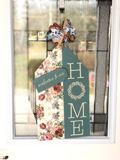 a house shaped door hanger with flowers on it