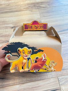 the lion king pin has been placed on top of a cardboard box with an image of simba and nala