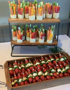 an assortment of appetizers are displayed on trays with toothpicks in them