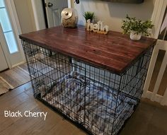 a dog in a cage on top of a wooden table