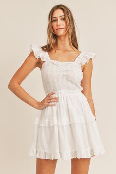 -Color: Off White -Sleeveless -Dotted swiss -Ruffle tier -Smocked bodice -Content: Self 100% Cotton; Lining 100% Rayon -Hand wash/Line dry -Imported -Model is 5'9" and wearing a size Small Summer Smocked Tiered Dress, Summer Smock Tiered Dress, Tiered Cotton Mini Dress With Smocked Back, Cotton Smocked Dress With Ruffled Straps, Fitted Sleeveless Tiered Dress With Smocked Back, Cotton Smocked Mini Dress With Ruffles, Sleeveless Cotton Tiered Dress For Daywear, Cotton Tiered Dress With Smocked Bodice, White Sleeveless Cotton Tiered Dress