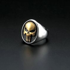 Gold Plated Tone Stainless Steel Mens Biker Punisher Skull Ring Size 7-15. Introducing The Ultimate Symbol Of Power And Rebellionthe Punisher Skull Ring! Crafted With Meticulous Attention To Detail And Designed To Captivate, This Extraordinary Piece Of Jewelry Is A Must-Have For The Modern-Day Warrior. Size: 7”,8”,9”,10”,11”,12”,13” * Send Message With Size Choice To Check Availability Or One Available Will Be Picked For You. Material: 316 L Stainless Steel Ring Height: 26 Mm Color: Gold & Silve Silver Jewelry With Skull Print For Streetwear, Silver Skull Print Jewelry For Streetwear, Silver Skull Ring For Halloween Streetwear, Silver Biker Jewelry For Streetwear, Silver Skull Ring For Streetwear, Skeleton Ring, Punisher Skull, Silver Skull Ring, The Punisher