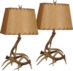 two lamps with antlers on them sitting side by side, one is brown and the other is beige