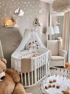 a baby's room with a teddy bear and crib in the corner, stars on the wall