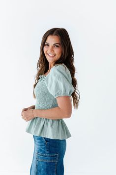 Features Square neckline with ruffle detailing Short sleeve with elastic Smocked bust Sage color 100% Cotton Size + Fit Small 0-4, Medium 4-8, Large 8-12 Kristin is 5'4", a size 1 and is wearing a Small Runs true to size Click here for skirt shown in photos Curvy Swim, Sage Color, Smocked Top, Curvy Dress, Resort Collection, Black Sand, Swim Bottoms, Mommy And Me, Square Neckline