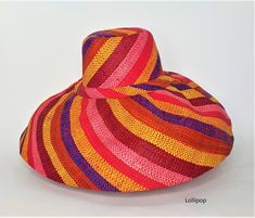 Raffia Curve Large Brim Hat in Lollipop      These amazing hats are dyed, loomed and sewn all by hand. Made in Madagascar. The hats are great sun protection having 2 layers on the brim and around the crown, 3 layers for crown top. Hats can be rolled up for packing in handbag or suitcase.       Measures 15cm brim.      Ethical, eco-friendly, sustainable.      About Raffia      Raffia is native to Madagascar and a sustainable resource to the country. Collectors go deep in the island to harvest the Multicolor Straw Hat With Flat Brim, Multicolor Toquilla Straw Hat With Curved Brim, Handmade Multicolor Straw Hat For Spring, Multicolor Wide Brim Toquilla Straw Hat, Multicolor Woven Hats With Flat Brim, Multicolor Toquilla Straw Sun Hat, Multicolor Brimmed Toquilla Straw Hat, Multicolor Brimmed Toquilla Straw Sun Hat, Multicolor Flat Brim Toquilla Straw Hat