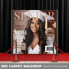 a red carpeted backdrop with an image of a woman's face on it