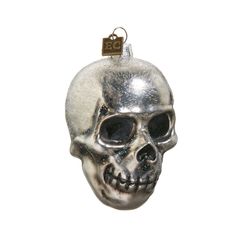 a silver and black skull ornament hanging from a hook on a white background