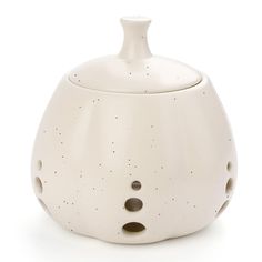 a white ceramic vase with holes in it