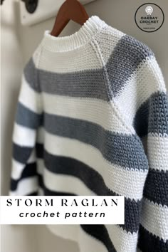 a white and black striped sweater hanging from a hook on a coat rack with text reading storm rag crochet pattern