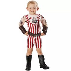 a little boy dressed up in a costume with an american flag on the chest and arms