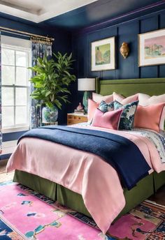 a bedroom with blue walls and pink bedding