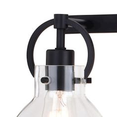 an industrial style light fixture with clear glass and black metal fittings on the arm